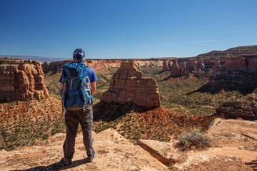 Hiker is sitting on the cliff in Colorado National monument, USA