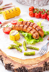 grilled krakauer sausage with boiled corn and green salad