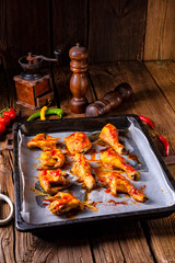 Rustic backed chicken wings,legs on baking tray