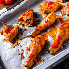 Rustic backed chicken wings,legs on baking tray