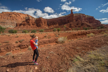 Fototapeta premium A mother and her baby son visit Capitol reef National park in Utah, USA