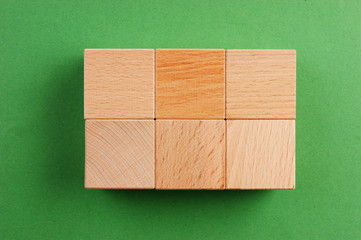 wooden geometric shapes on a green background
