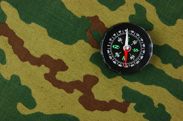 Compass on a camouflage background
