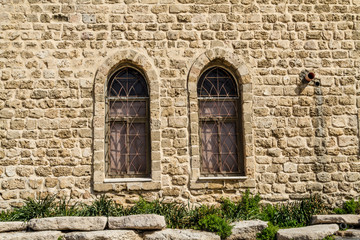 Vintage lancet windows on the background sandstone bricks