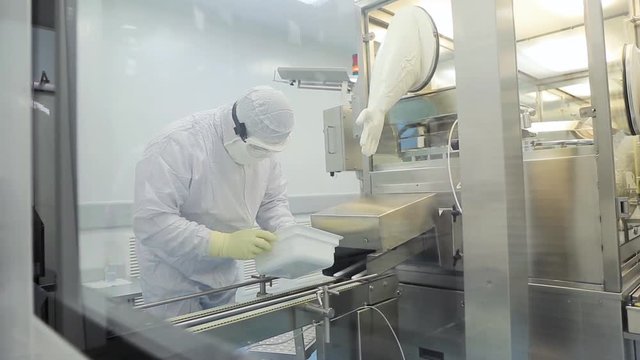 Pharmaceutics. Pharmaceutical worker operates blister packaging machine. Quality control. Pharmaceutics. Worker operator portrait
