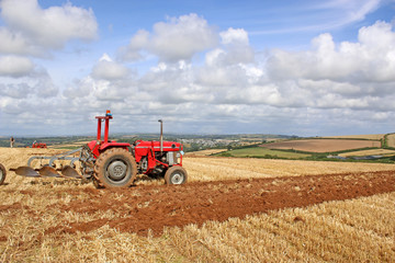 Obraz premium Vintage tractor and plough
