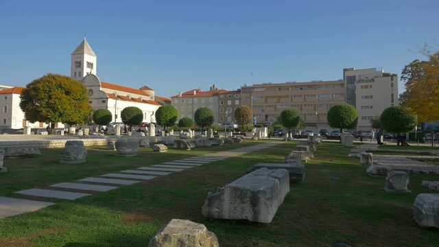 A city square with ruins and trees