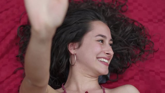 shy beautiful sensual woman smiling at the camera lying