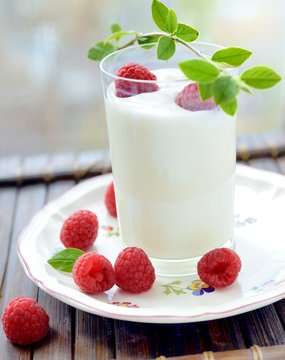 Yogurt with fresh berries on dark background