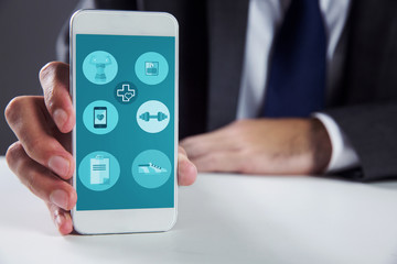 Businessman using smartphone against fitness apps