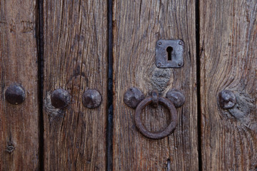 An antique iron door handle. Texture of an old tree.