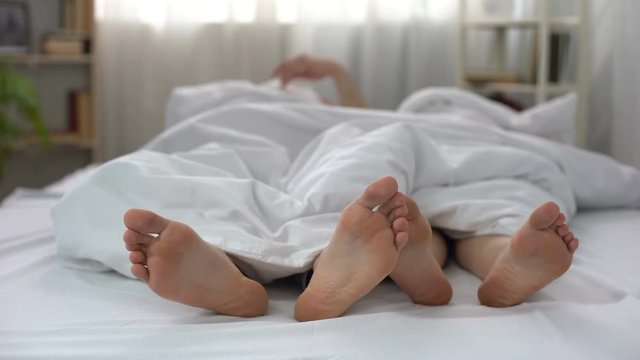 Husband and wife nervously pulling blanket in bed, family quarrel, conflict