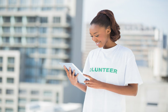 Woman wearing volunteer tshirt using tablet pc