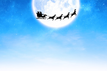 Obraz na płótnie Canvas Silhouette of santa claus and reindeer against winter snow scene