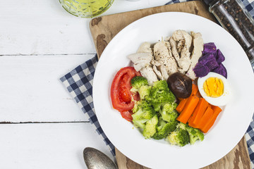 Boiled chicken breasts and vegetables with sports and diet concepts.