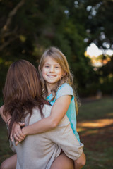 Fototapeta premium Mother holding her daughter in arms