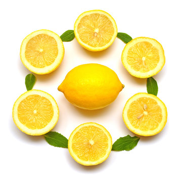 Lemon whole and sliced with leaves isolated on white background. Flat lay, top view