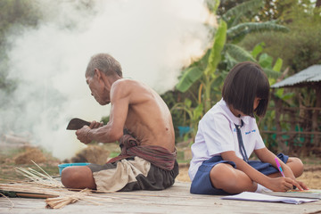 Grandfather and granddaughter at countryside.Living in rural Asia