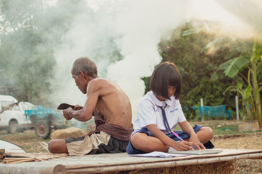 Grandfather and granddaughter at countryside.Living in rural Asia