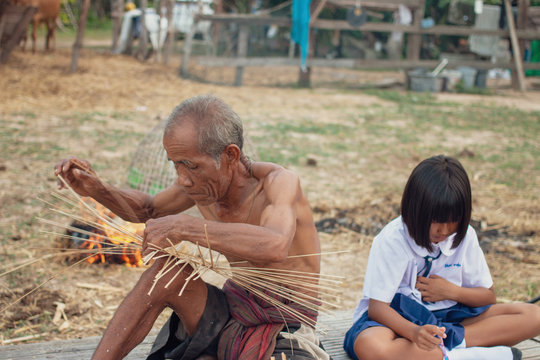 Grandfather and granddaughter at countryside.Living in rural Asia