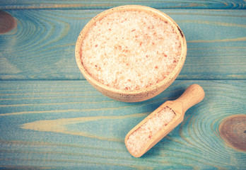 Pink Himalayan salt on a blue background.