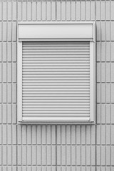 White metal shutter window and white brick wall background