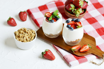 Healthy Breakfast Concept. Muesli with Greek Yogurt, Strawberries and Blueberries, Diet, Summer Food. White Background, Close-up, Flat lay