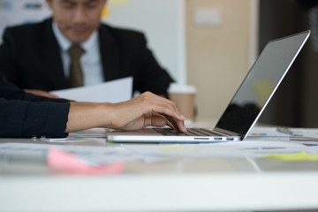 Young Asian business woman are working on a laptop in the room for business meetings.