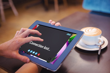 Music app against  close-up of digital tablet and coffee on table Close-up of digital tablet and coffee on table in the coffee shop