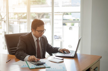 Business man working at office with laptop computer and documents financial reports
