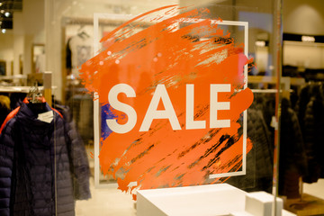 SALE Sign on the shop's window display.discount sign on show window. Sale sign, symbol in clothes...
