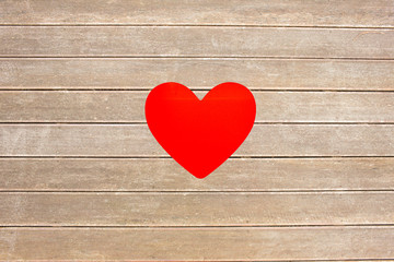heart against wooden surface with planks