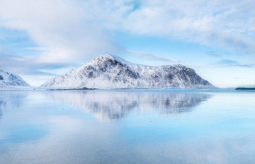 Fototapeta na wymiar Mountain ridge and reflection on the seashore. Natural landscape in the Norway