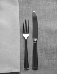 cutlery on a linen tablecloth with a napkin


