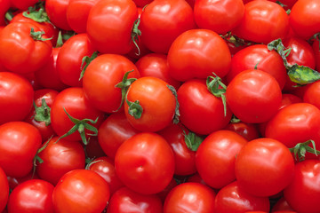 A pile of red tomatoes as background, texture