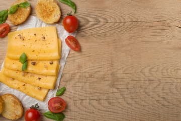 Cheese with cherry tomatoes and basil, nuts and toast from baguette