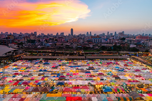 Sunset Sky Over Flea Market Roof To Night Light Cityscape