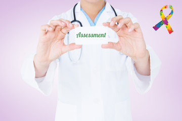 The word assessment and doctor holding card  against purple vignette