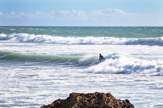 Surfer in the Atlantic Ocean. The coast of Agadir. Morocco