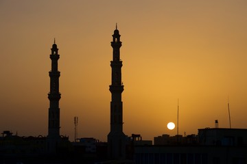 Fototapeta na wymiar Sunset against the minarets at Hurghada on Red Sea in Egypt