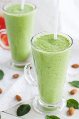 Fototapeta na wymiar Green smoothie with spinach, grapefruit and almond milk