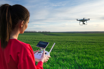 Female flying a drone at the field