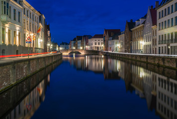 Fototapeta na wymiar View of a canal and old historical buildings in Bruges, Belgium at dusk
