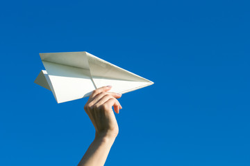 Happy kid playing with paper airplane