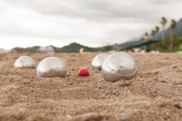 Fototapeta na wymiar Beach. A game of Bocha. Brilliant silver balls for a bocha on the sand.
