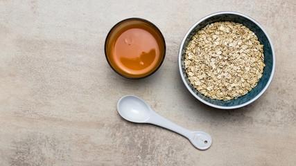 Bowl of oatmeal porridge with carrot juice.