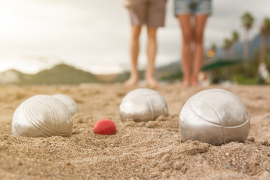 Beach. A game of Bocha. Brilliant silver balls for a bocha on the sand.