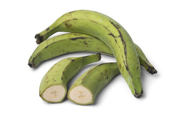 Whole and half green unripe bananas