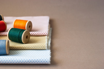 Fototapeta na wymiar Fabrics and threads for sewing.