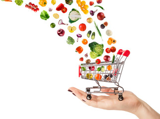 Collage of shopping cart with vegetables and fruits isolated on 